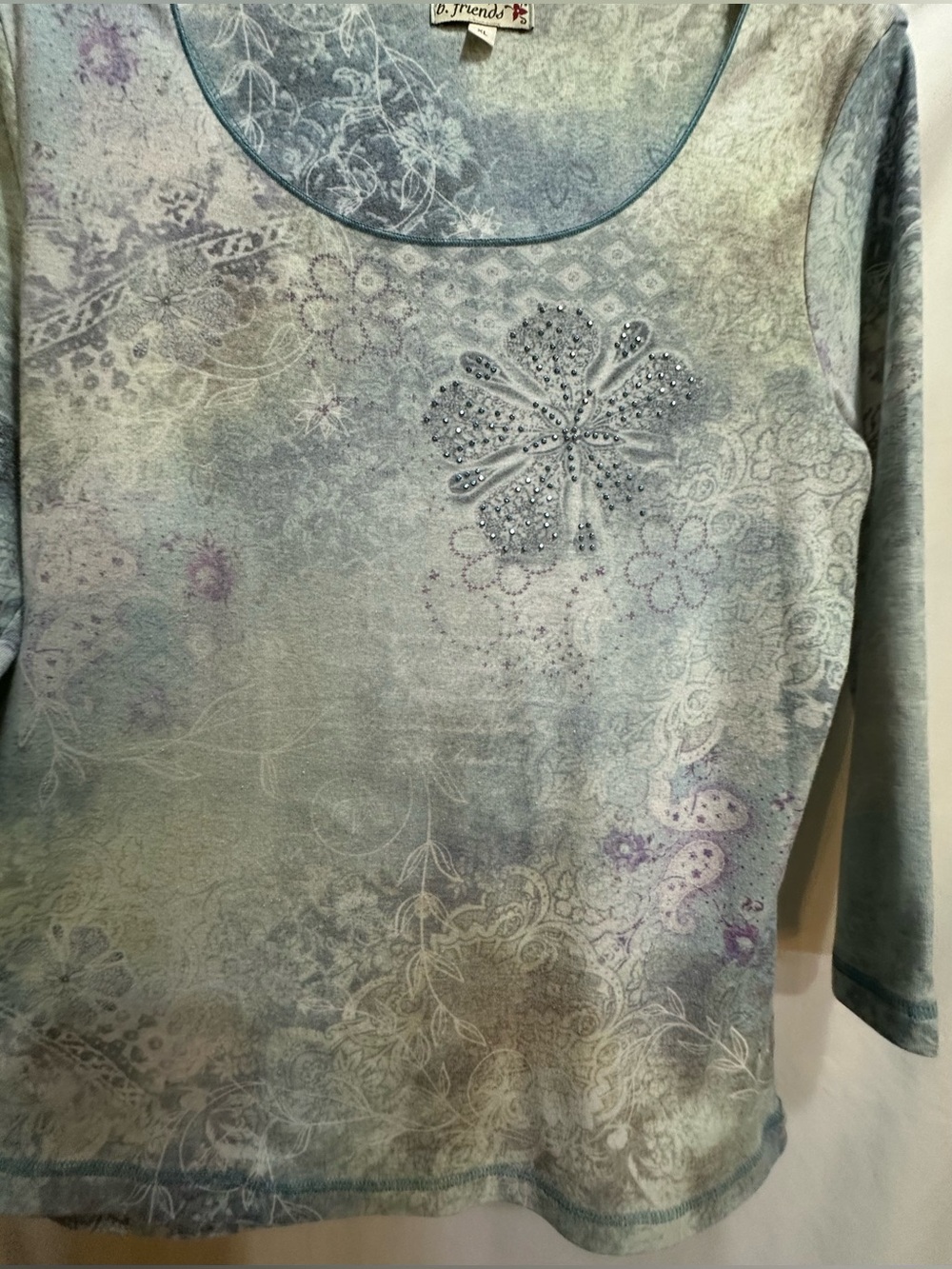 Light Blue Floral Scoop Neck Women's Top with a front flower with gem accents. - Picture 5 of 9